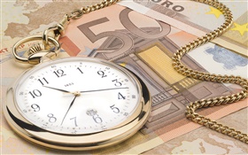Relógio e moeda Euro
